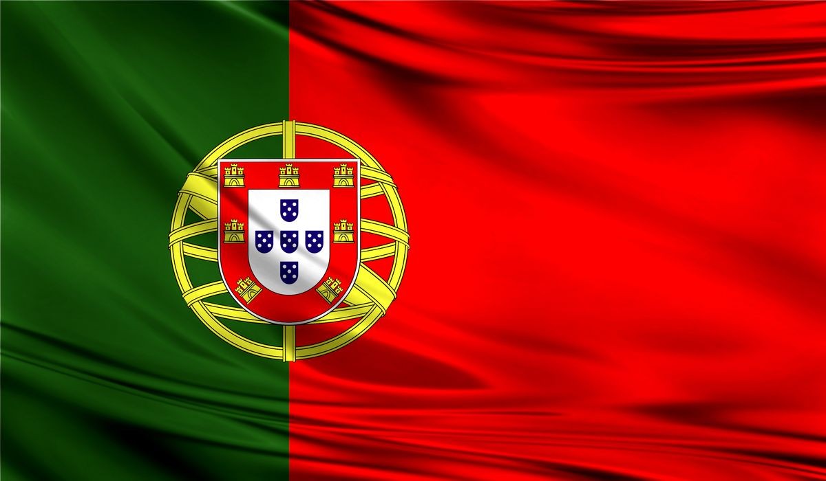 Grunge colorful background,flag of Portugal. Close up, fluttering downwind